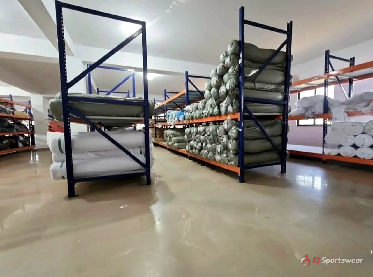 Fabric store with rolls of sportswear fabric on racks